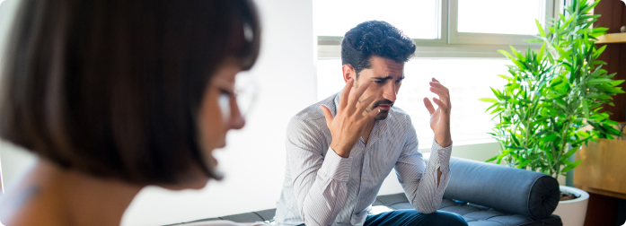 An attentive man in conversation with a woman
